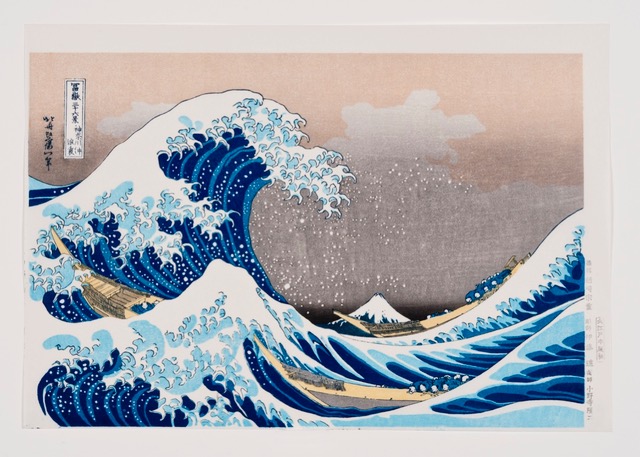 Hokusai print - Under the Wave off Kanagawa - A giant blue and white ocean wave is about to crash, with Mt. Fuji in the curl of it in the distance.