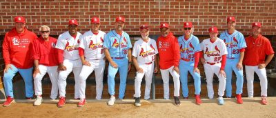 11 older men in baseball and manager uniforms